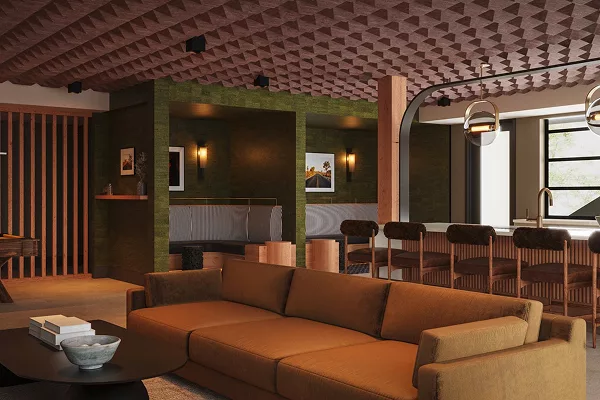 Indoor lounge with brown sofas, green walls, and bar stools